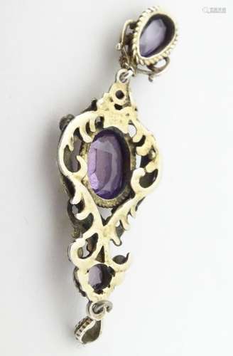 A white metal pendant set with amethysts and seed pearls,