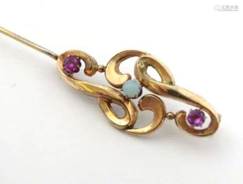 An Art nouveau gold brooch set with amethysts and central opal.