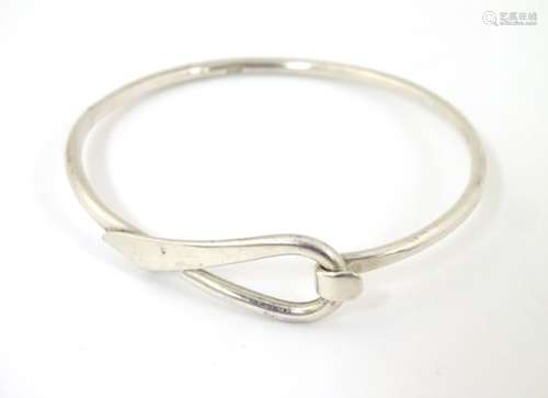 A silver bracelet of bangle form CONDITION: Please Note - we do not make reference