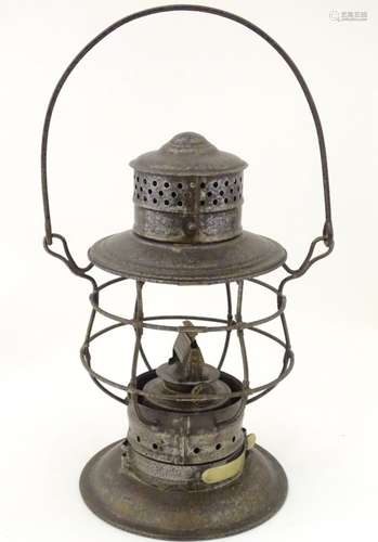 An oil lantern with carrying handle,