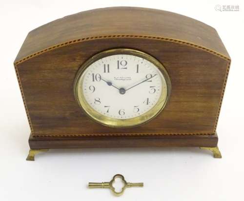 An Edwardian mantle clock, having a continental movement, the enamelled dial signed 'R.H.