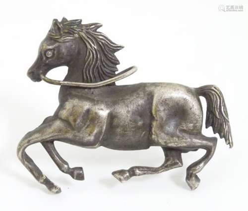 Equine Interest : A white metal brooch formed as a galloping horse.