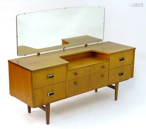 Vintage Retro: a mid Century teak dressing table having 6 drawers, bears remains of label verso,