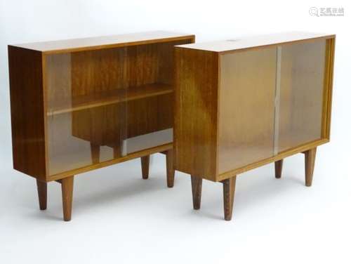 Vintage Retro - a pair of English mid 20 thC 'Gordon Russell' Walnut low bookcases with sliding