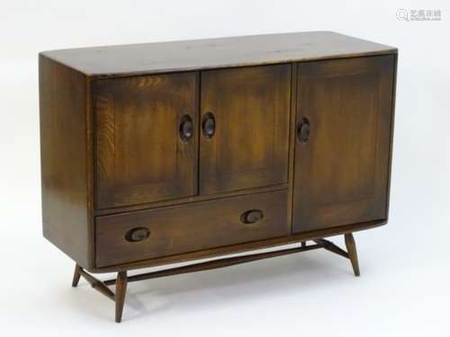 Vintage Retro: A dark elm Ercol sideboard with two cupboard doors above a single long drawer