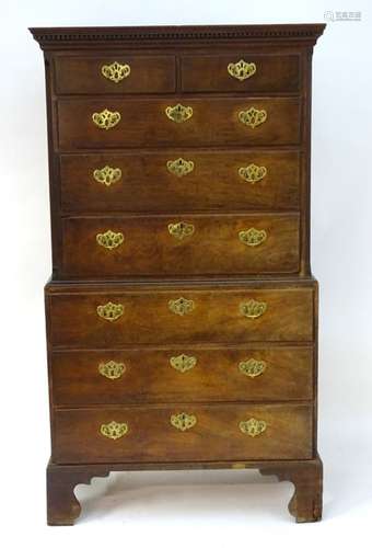 A 19thC chest on chest with a moulded cornice and dentil carved frieze above two small drawers and