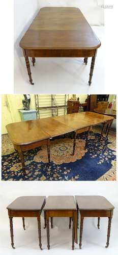 A 19thC mahogany D-end dining table with decorative stringing to the frieze and raised on turned