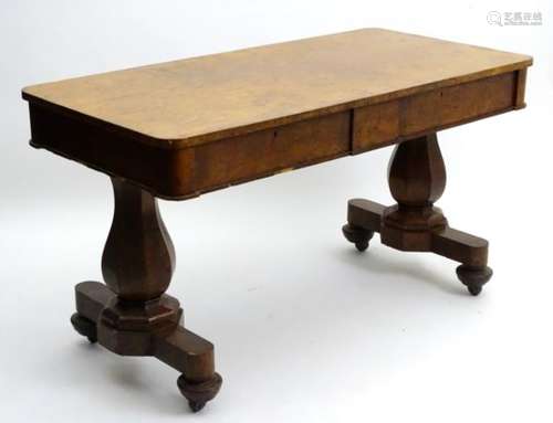 A mid 19thC pollarded oak library table with two frieze drawers above canted supports and base,