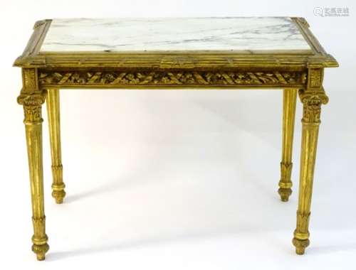 A mid 19thC marble topped centre table with a gilt wood base having a carved frieze with floral