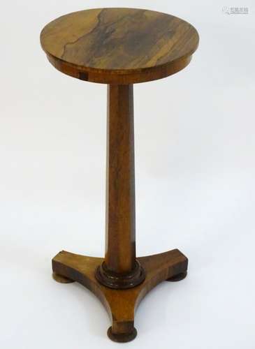 A mid 19thC rosewood lamp / wine table with a circular top above a canted stem and triformed base