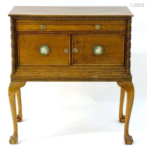 A late 19thC / early 20thC walnut cabinet on stand, having a rectangular top above a moulded frieze,