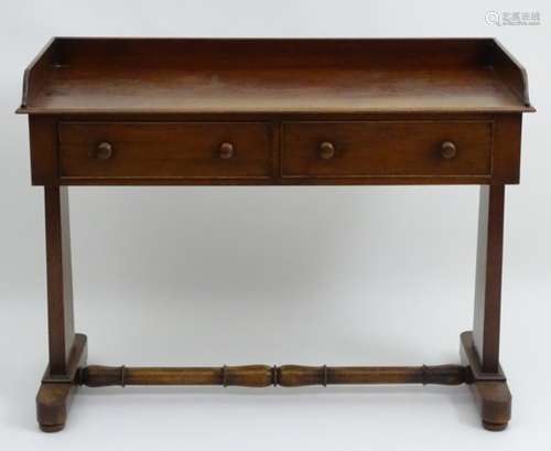 A mid 19thC mahogany wash stand with a shaped up stand above two short frieze drawers and raised on