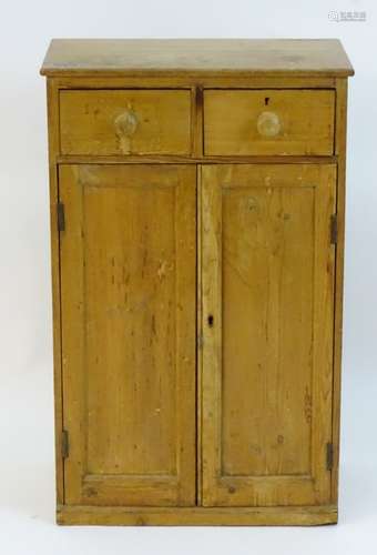 An early / mid 20thC pine cupboard with a rectangular top above two short drawers and two panelled