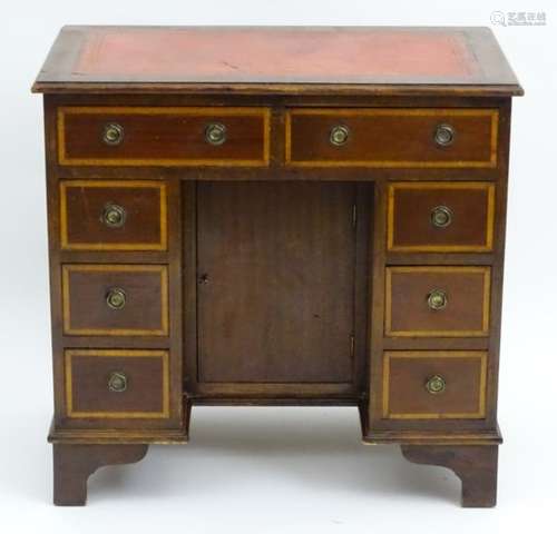 An early 20thC mahogany kneehole desk,