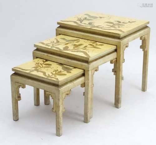 An early 20thC nest of three tables Oriental tables with decoration to the tops and brackets to the