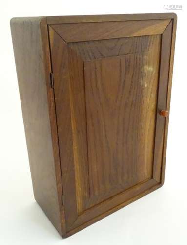 A mid-20thC oak cabinet with two internal shelves, 13