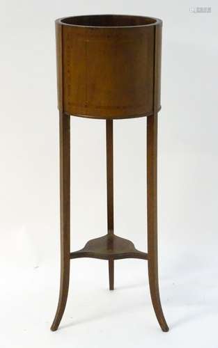 An early 20thC mahogany jardiniere with satinwood crossbanding,