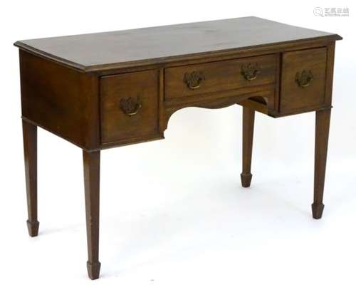 A mid 20thC mahogany desk with a moulded rectangular top above single central drawer and two deep