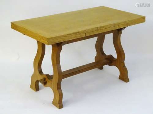 An early / mid 20thC oak draw leaf table with a shaped trestle base.