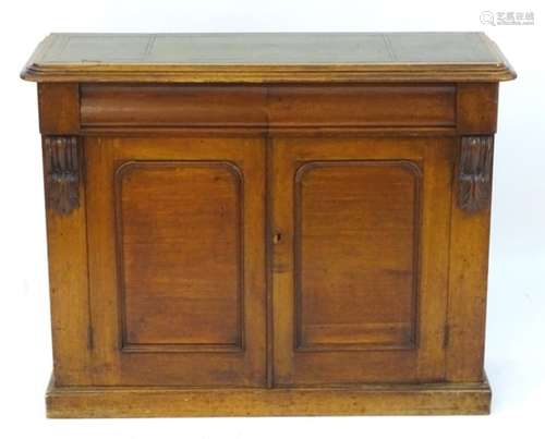 A late 19thC mahogany chiffonier with an inset leather top above two panelled cupboard doors