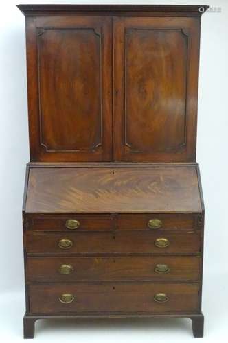 A George III mahogany bureau bookcase, with checkered decoration to the top and base.