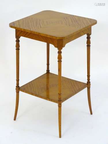 A mid 20thC satinwood occasional table with a square top above four turned tapering legs and a