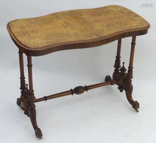 A late 19thC walnut table with an inlaid top and standing on turned legs with carved decoration and