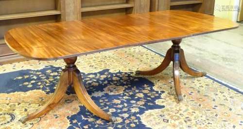 A mid 20thC mahogany pedestal dining table,