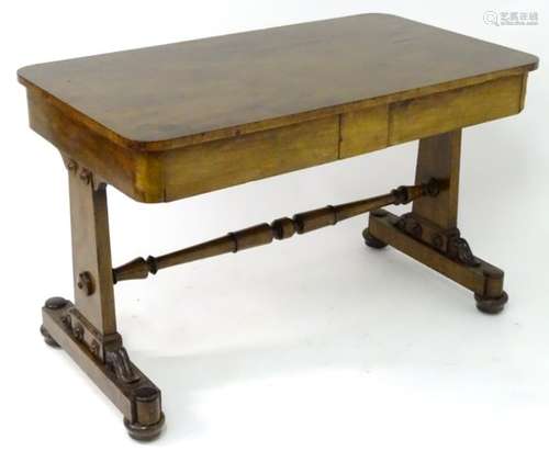 A 19thC mahogany library table with a rectangular top above two supports with roundel decorations