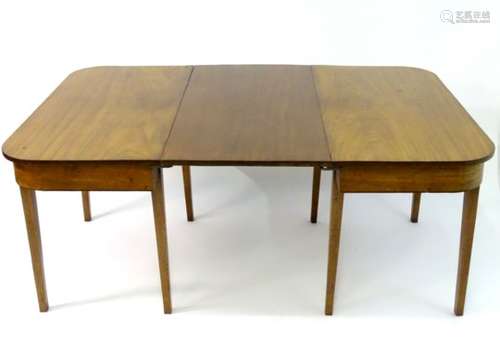 A 19thC mahogany D-ended dining table raised on tapering squared legs and having an additional leaf.