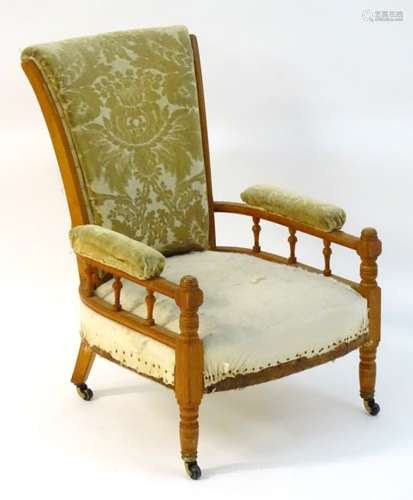 A late 19thC Aesthetic movement satinwood open armchair attributed to E.