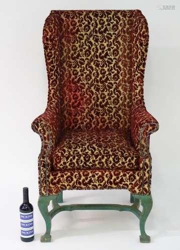 A late 19th / early 20thC Continental slim wingback armchair,