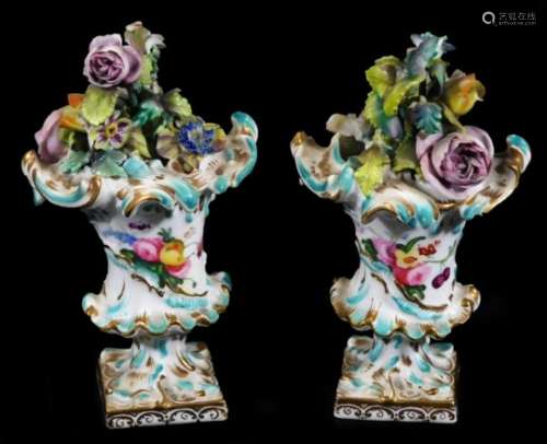 A pair of late 18thC continental porcelain baskets, each richly decorated with flowerheads, of
