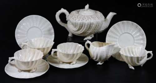 A Belleek 2nd period porcelain part Nautilus pattern tea set, comprising teapot and cover on shell