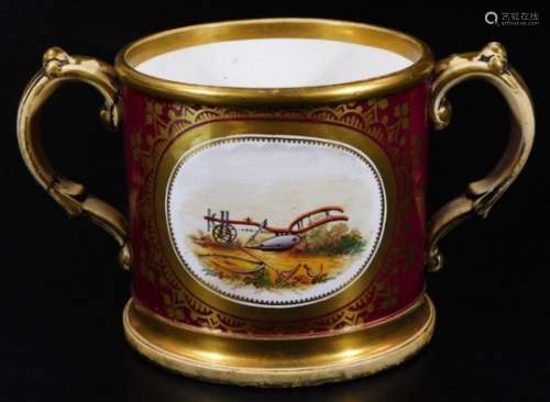 A Coalport two handled loving cup, decorated with a plough within a claret ground, the reverse