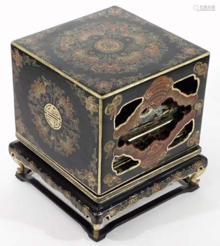 An early 20thC lacquered dowry chest, decorated with gilt oriental designs, raised on four feet,