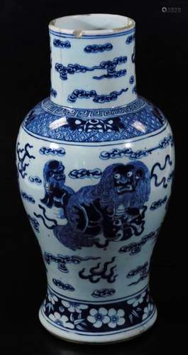 An early 18thC Chinese blue and white vase, decorated with lions and dragons, on a cloud ground,