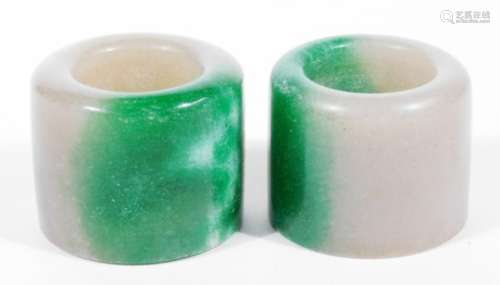 Two jade rings, in green and white colours, each approx 4cm H. (2)