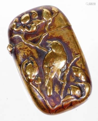 A Japanese polished brass vesta case, of oblong form raised with bird on elaborate tree bough,