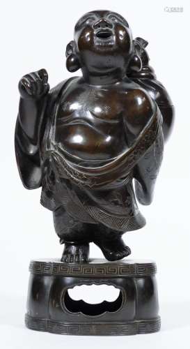 A Japanese Meiji period bronze figure group and cover, formed as a figure, semi-clad in flowing
