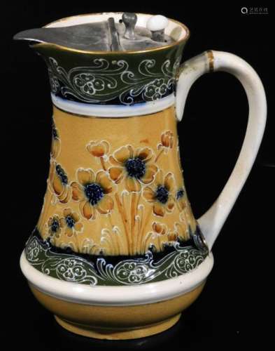 A James Macintyre & Co pewter lidded milk jug, decorated with tube lined flowers on a cream ground