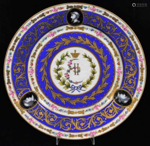 An early 19thC Continental porcelain plate, decorated with classical figure heads within a blue