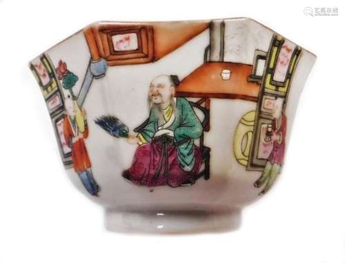 A Chinese porcelain octagonal bowl, decorated with trellis panels, figures holding tea, brush and an