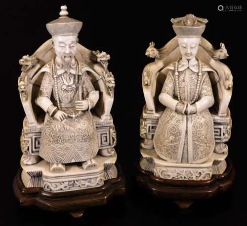 A pair of finely carved 19thC Chinese ivory figures, of a lady and gentleman, each in Imperial dress