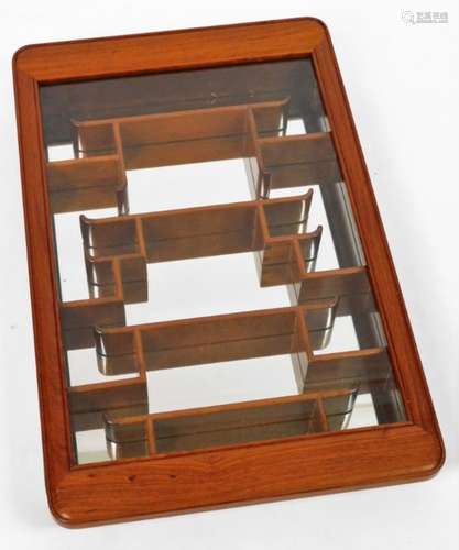 A Japanese glazed cabinet, in hardwood, with shaped shelves showing visible dovetails with plain