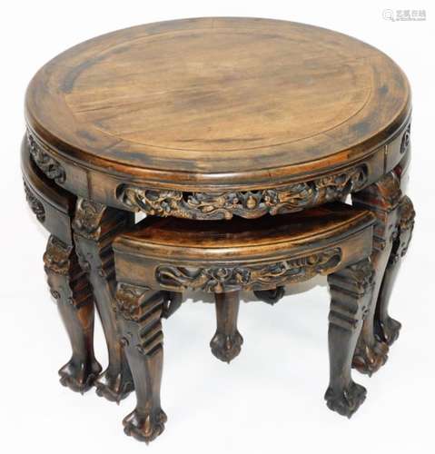 A Chinese Qing period low table and stool nest, with quarter stool chairs, of circular form, with