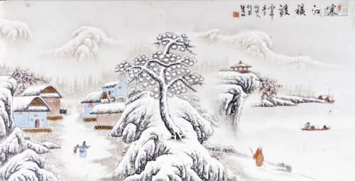 A Japanese porcelain panel, with figures in a winter landscape before buildings and mountains,