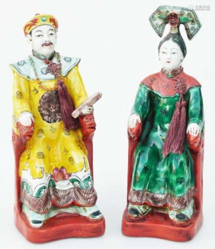Two early 20thC pottery figures, of seated figures in flowing robes,