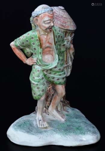 A Japanese Meiji period pottery figure, of a gentleman in flowing robes holding large basket aside