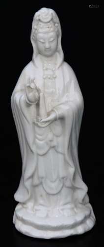 A Chinese blanc de chine porcelain figure, of a lady standing in flowing robes holding candle, on